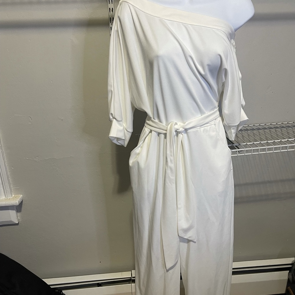 Cream jumpsuit with belt.